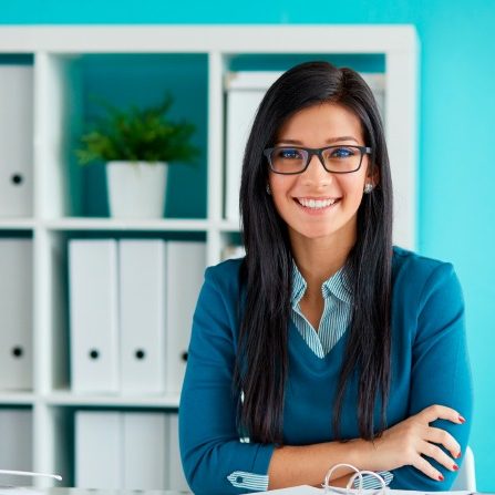 Young businesswoman with glasses working in modern office